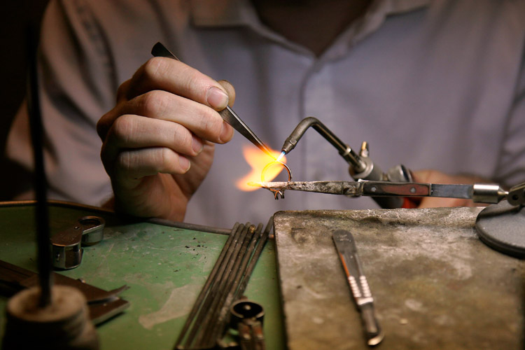 A jeweler in a diamond store in Antwerp, Belgium, welds the band of a ring together before filing it smooth. As the center of the world's diamond trade, Antwerp deals with about 80 percent of all diamonds  after mining.<p>