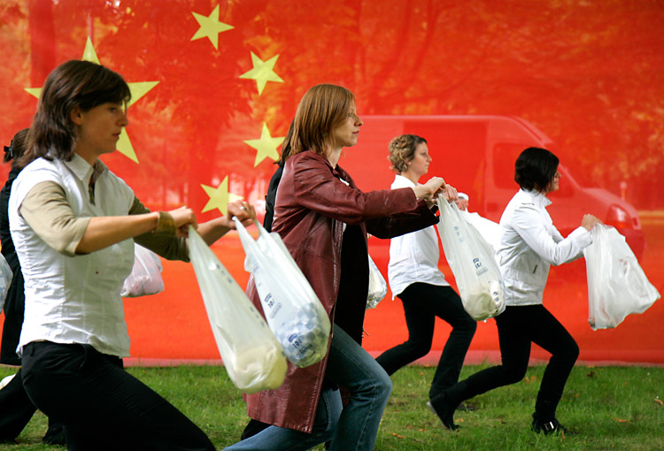 Amnesty International protesters perform a dance in front of the Chinese embassy in Brussels, Belgium, on the 20th anniversary of the Tiananmen Square massacre in China. The protesters' bags reference the bags held by a man who faced Chinese government tanks on the square.